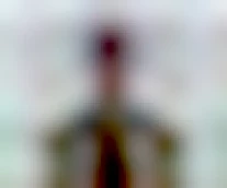 Red Dwarf S03E01 Backwards. Image shows Cat at the end of the episode, in the grass to have a shit before entering Starbug. But being the backward planet, where everything happens backward, Cat is shown with an unpleasantly surprised look on his face, with messed up hair