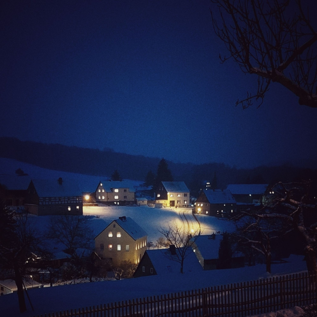 A mountain village on a winter evening. Light in everything.