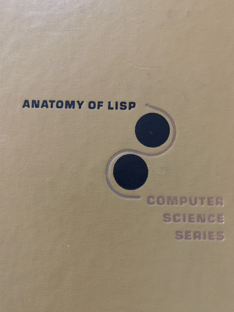 Very plain book cover. Anatomy of Lisp, Computer Science Series. Two black dots with an S shape around them.