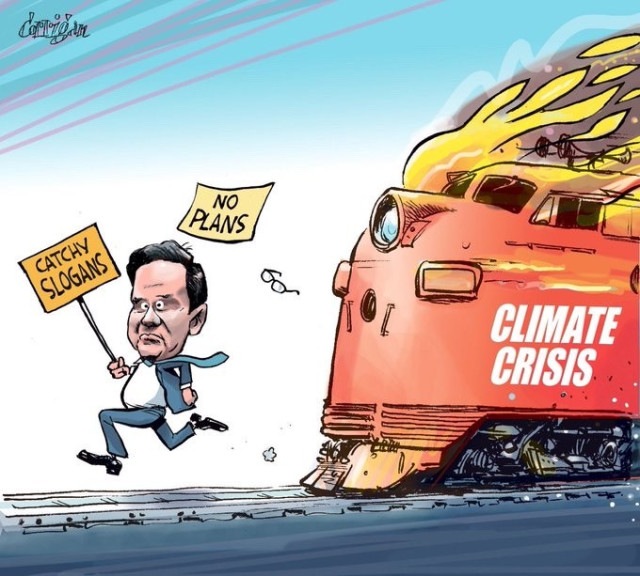 Poilievre trying to outrun a train on fire , labelled Climate Crisis. He is carrying a sign that reads “catchy slogans, No plans”. Credit : Patrick Corrigan