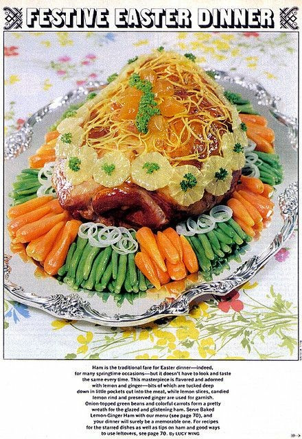Page from an old magazine. The page title reads Festive Easter Dinner. A photo of an unidentifiable mound, covered in slices of lemon, ginger, and sprigs of parsley. It's surrounded by carrots, onions and peas. Only by reading the description can you find out that there's a ham under all that garnish.