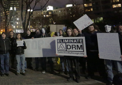 People outside protesting DRM.