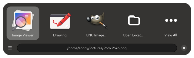 A screenshot of Junction.

There is a row of 5 icons.

Image Viewer, Drawing, Gimp, "Open Locat...", and "View All"

Below there is a row with a menu button, a text entry with a file path for a ping file and a close button.