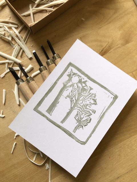 Linocut print : a view of 3 trees in perpective, sage green ink.