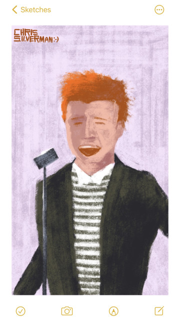 A person with fiery red hair, a formal suit jacket, and a severely striped black-and-white shirt sings in front of a microphone about how he's never going to give you up and let you down. The background is lavender, because the 1980s.