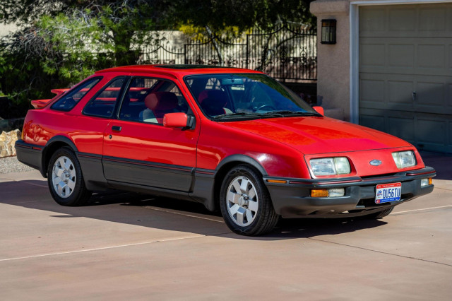 1987 Merkur XR4Ti. The short-lived Merkur marque was Ford's attempt to bring cars developed by its European subsidiaries to the U.S. market as captive imports. The XR4Ti was a rebadged version of Ford Europe's sporty three-door Sierra hatchback. This one's red, with black cladding along the bottom.