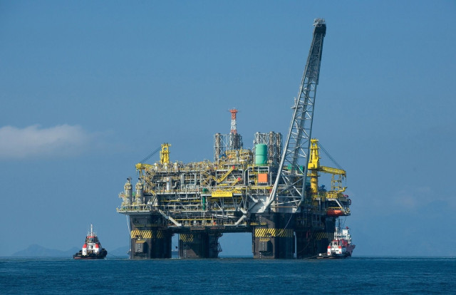 an oil platform in the ocean.