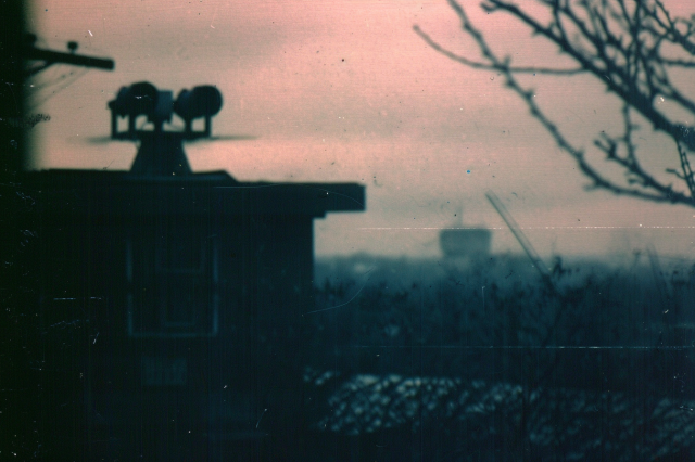 A roof-mounted listening post in a suburban setting on a grey cloudy day