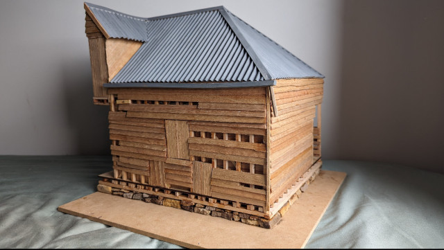 A timber model of a tall shearing shed. Tin roof. 