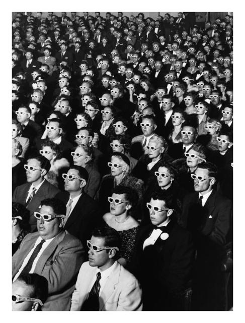 well-known black and white 1952 life magazine photo. high-angle view of well-dressed audience in a movie theatre. everyone is wearing 3-D viewing glasses. almost all are looking up at the movie screen,

Credit: J.R. Eyerman/Life Pictures/Shutterstock
