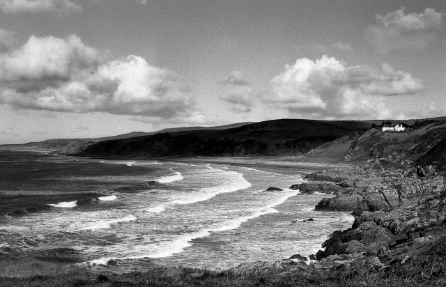 The sweeping curve of Killintringan Bay in the Rhinns of Galloway, with white-capped waves rolling into the rocky shore. Ilford FP4 shot with a Minolta X700 and developed in Ilford DDX.