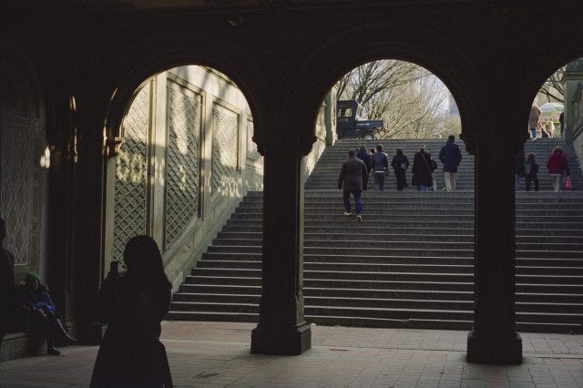 An archway leading out onto a wide set of stairs leading up.