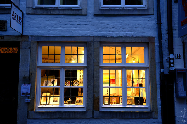 Two divided illuminated windows at late evening in the Schnoor district in Bremen.