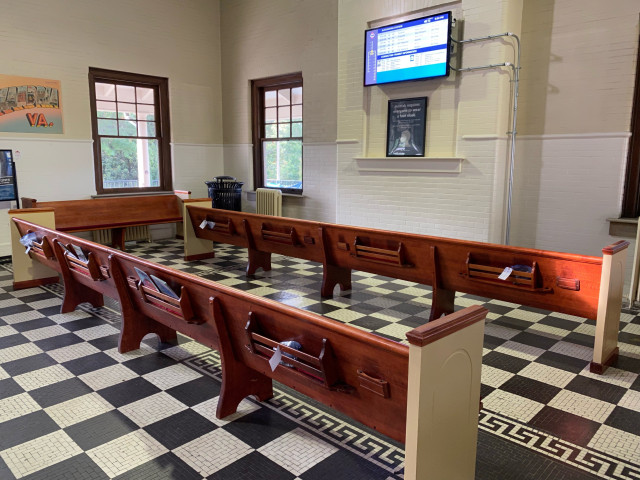 Church pews used for seating in the waiting room.