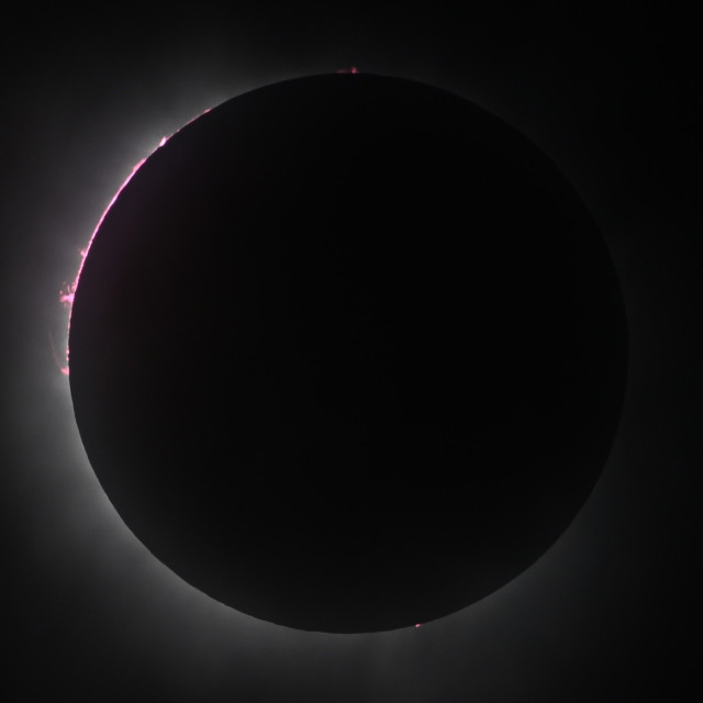 Short exposure at the start of totality, with chromosphere and prominences visible on the left side of the sun.