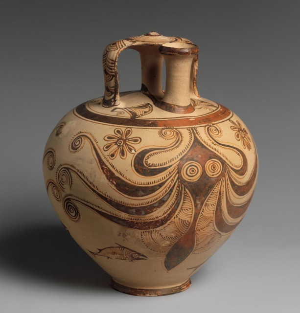 Description from the museum: “A stylized octopus flanked by fish covers each side of this stirrup jar, named for the shape of its handles. Mycenaean pottery often reflects Minoan-inspired themes and techniques that originated on the island of Crete. Animated marine motifs adopted from Minoan art began to appear on Mycenaean vessels in about 1500 BCE and were initially rendered in a very naturalistic manner. Here, the symmetrical composition and abstract depiction of the sea creatures are characteristically Mycenaean. Such jars were commonly used to transport liquids.”