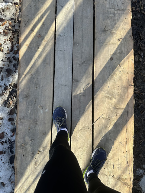 From upwards perspective, my running shoes on the wooden panels