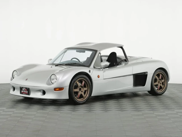 1997 Tommykaira ZZ. A low-slung, two-seat, open-topped (with detachable roof) sports car made in England for the Japanese market. This one's silver.
