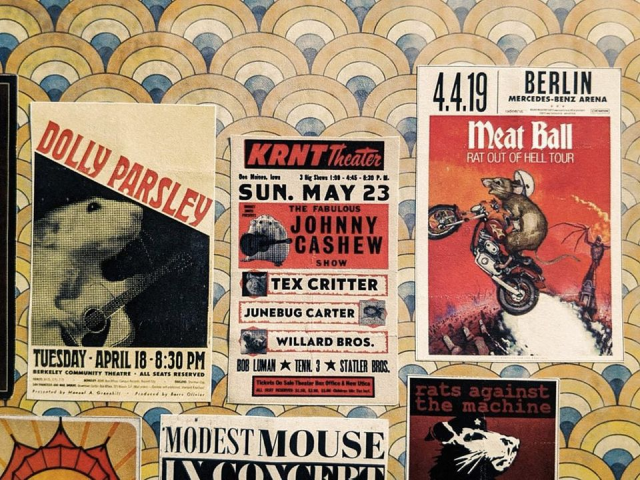 Teeny mouse-themed posters advertising  gigs by famous artists adorn a deco-papered wall.