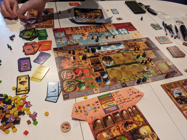 Shot of the worker placement board, round tracker, and one player area of Dungeon Petz 