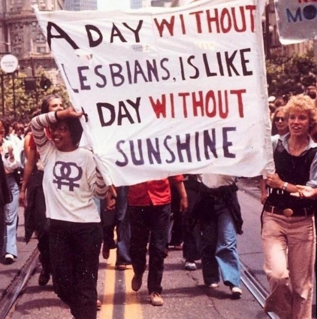 Images of protestors holding a sign that says "A day without lesbians is like a day without sunshine"