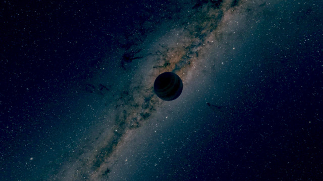 Artist's impression of a free-floating planet silhouetted against the Milky Way. 