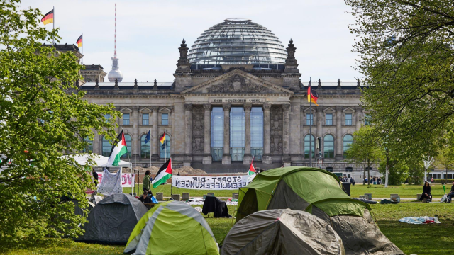 photo of Germany’s Parliament with tents set up in front of it