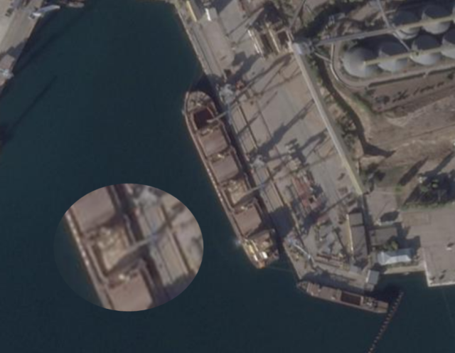 Planet Labs satellite image taken on October 19, showing a brown-yellow substance (likely grain) being loaded into the Zafar’s cargo compartments. Magnification added by Bellingcat. Credit: Planet Labs.
