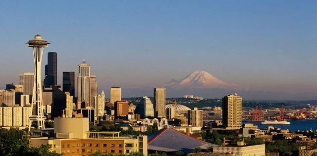 A photograph of Seattle's skyscrapers including the Space Needle and Mount Rainier. 