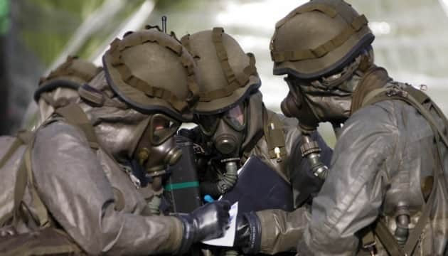 Soldiers in chemical suits