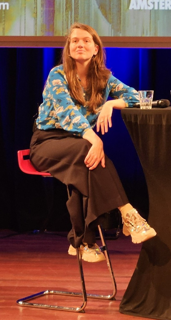 Kim van Sparrentak on a barstool during the panel discussion.