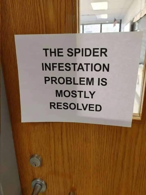 wooden door with a home-made sign on it that says: The spider infestation problem is mostly resolved.