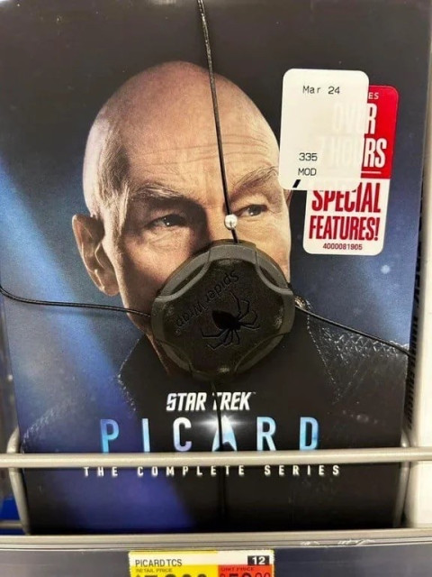 DVD box set of "Star Trek: Picard - The Complete Series" featuring the face of the titular character partially obscured by an anti-theft device and a sales sticker.
