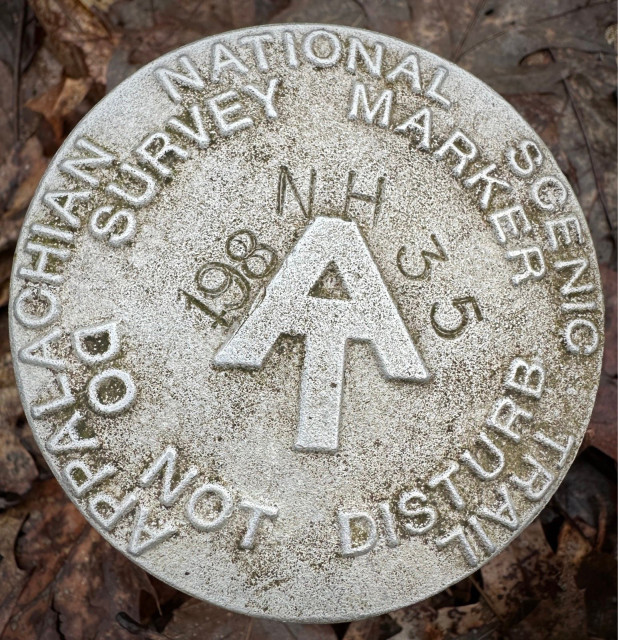 survey marker on side of trail for the AT