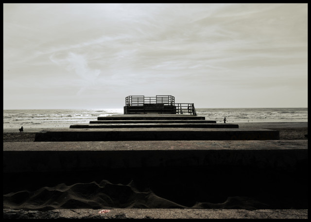 A series of concrete slabs lead out to a platform with metal railings overlooking the beach and waters of the Pacific Ocean.

Stark. Empty. Lacking color. And it's Sunday so I'm going back to bed.