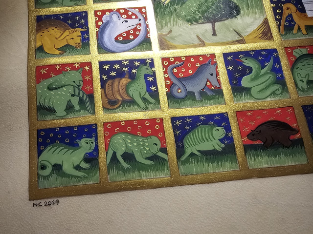 Close up picture of the illuminated bestiary. You can see blue and red vignettes, with fantastic beasts inside. They are all contained in a golden grid.