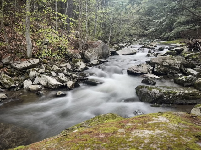 long exposure of a brook by the trail with the typical NH rocks and boulders and mosses