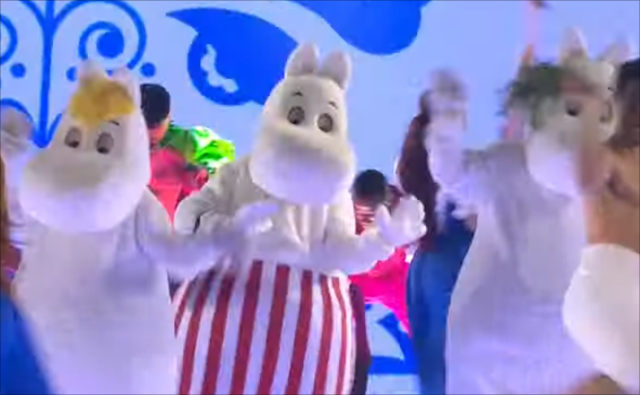 a bunch of people in moomin costumes dancing on a stage