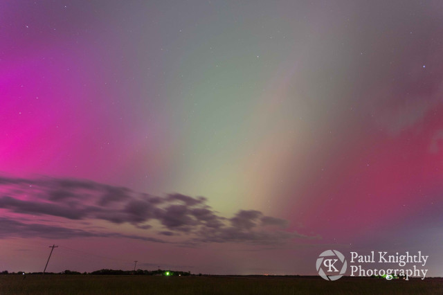 Purple to green to red aurora are visible in this image over a field in southeast Kansas.
