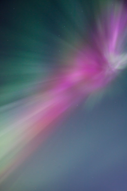 Another abstract explosion of pink and teal, expanding towards the viewer - looking almost directly up at the aurora.