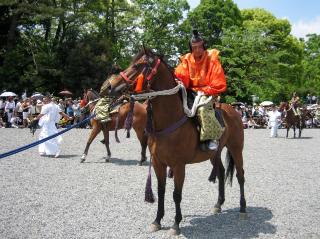 A horse and its rider rest during the procession of the Aoi Matsuri.