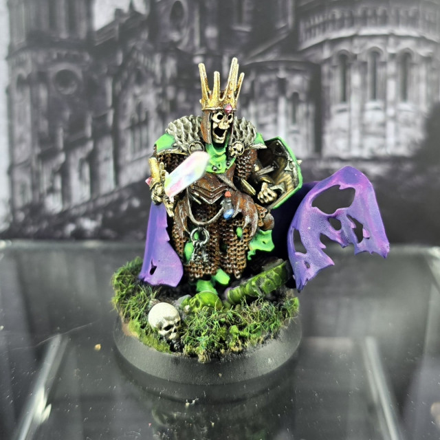Warhammer Wight Lord with prismatic sword, purple cape, bright green armour, rusty chainmail and red gems on a grassy base