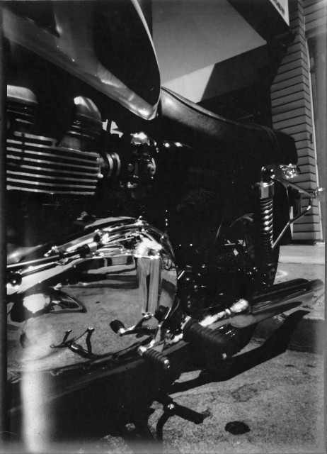 A black & white pinhole photo of a Triumph Bonneville motorbike