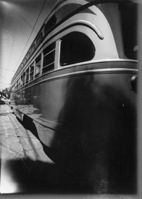 a black & white pinhole photo of an old streetcar on SF MUNI route F 