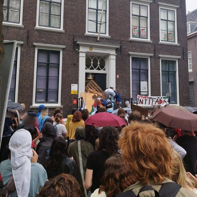 People in front of the new occupied UU building (see post). It's raining and people are barricading the door. A banner reads 'VIVA VIVA INTIFADA'

[from https://www.instagram.com/p/C6_hn-Co-I8]
