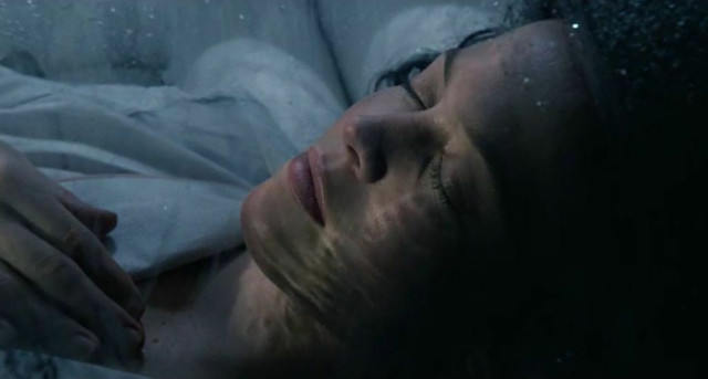 A sleeping woman with a light shining on her face