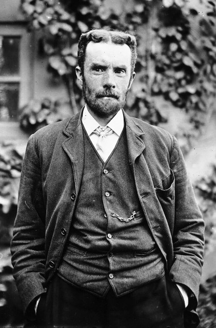 Oliver Heaviside.

A man with a beard and suit standing in front of a building.