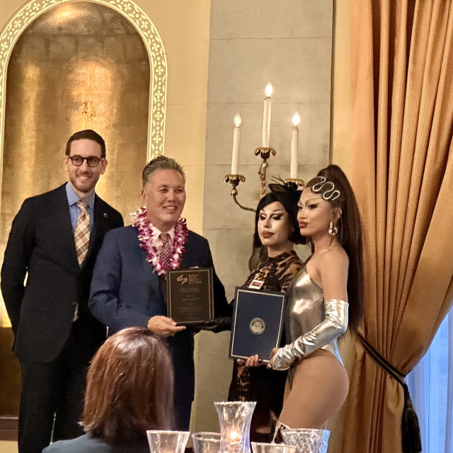 Scott Wiener, Mark Takano on stage with drag queens from San Francisco presenting Congressman Takano with an award 