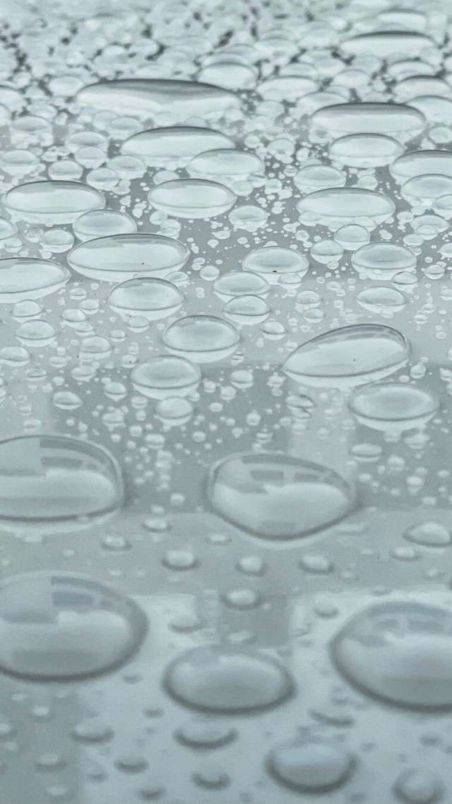 Raindrops on a smooth reflective surface.