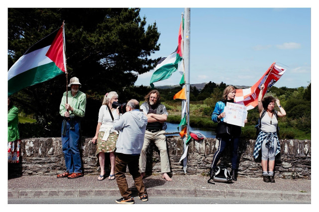 A group of people with Cork and Palestine flags in a show of solidarity with the people of Palestine on the Ballydehob bridge being photographed by my friend and press photographer Carlos.